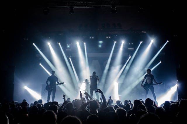 A band plays in front of a lively audience.