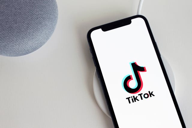 A phone screen displays the TikTok logo and name.