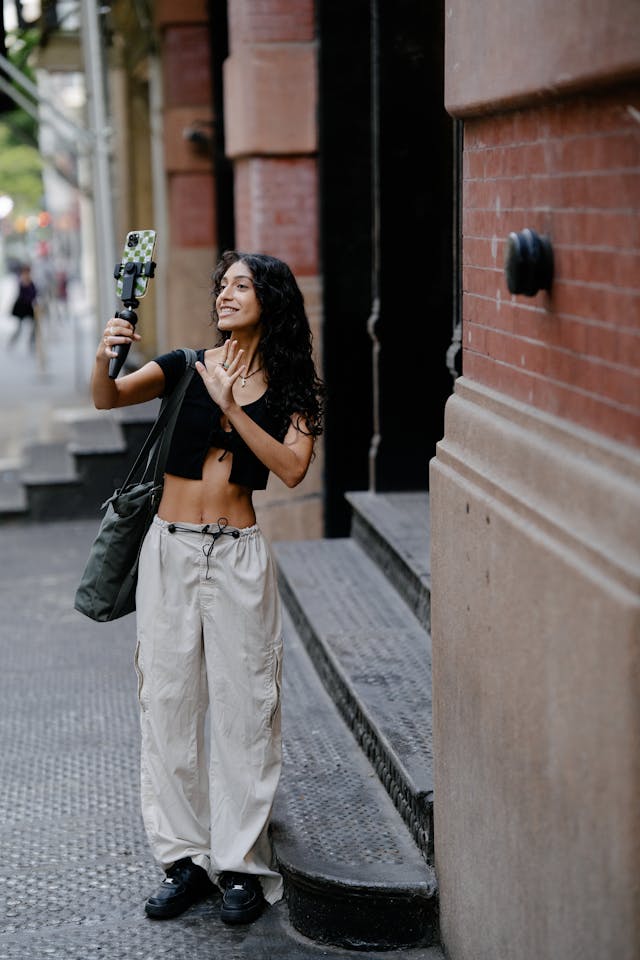 A woman records with her selfie stick.