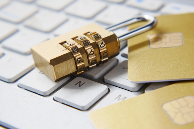 A gold padlock sits on top of a laptop keyboard.