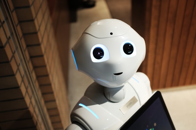 A white robot looks up at the camera.