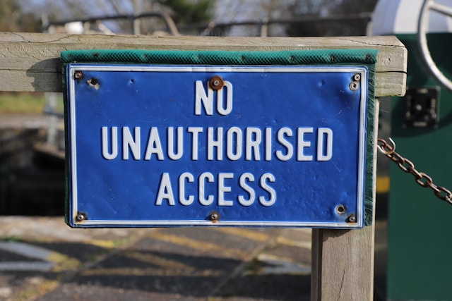 A blue and white sign says, “No unauthorized access.”