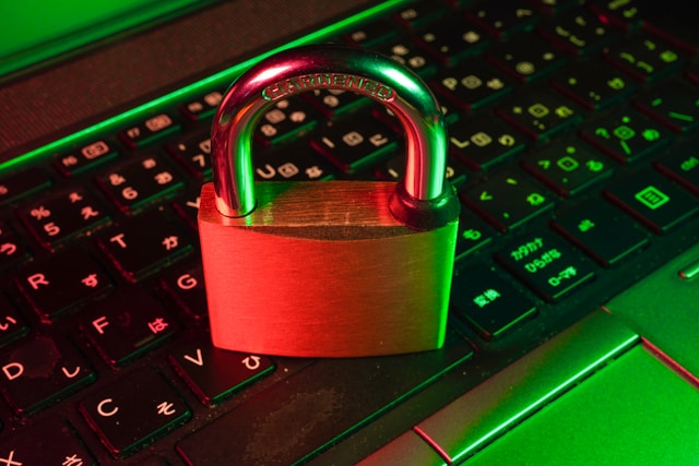 A locked padlock sits on top of a computer keyboard.