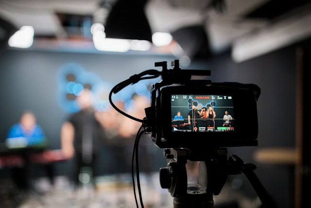A video camera is set up to capture a band performing.