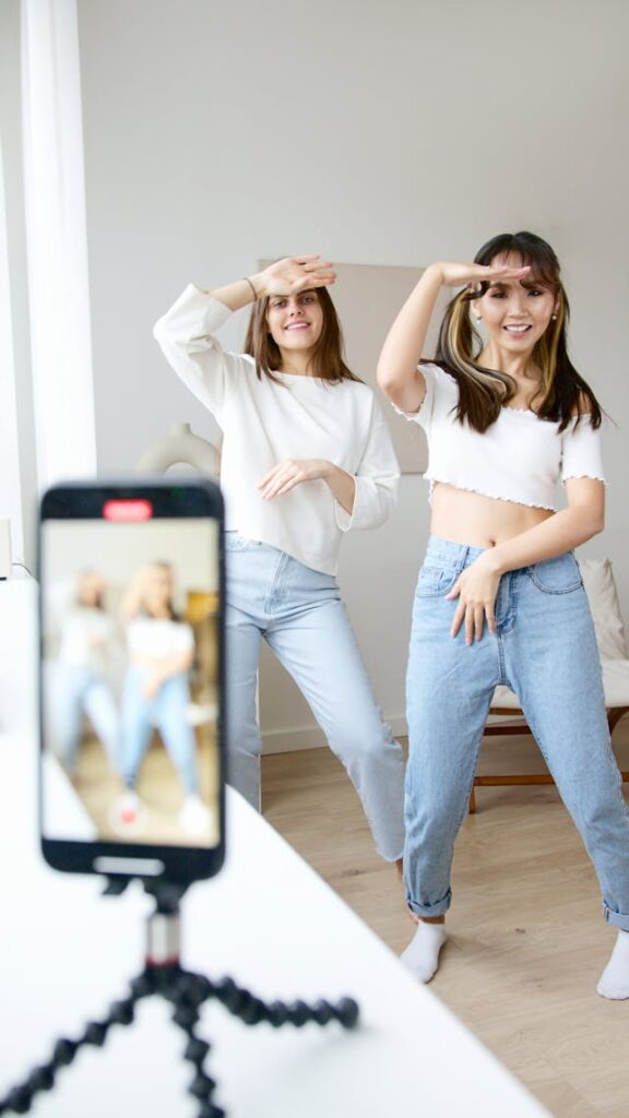 Two women dance for a video.