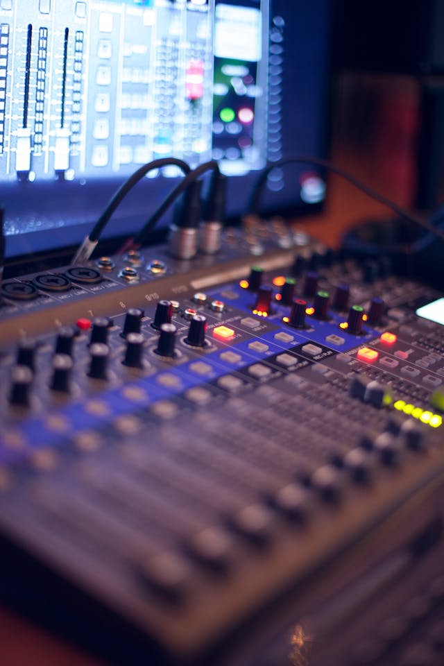 A close-up shot of an audio-mixing console.