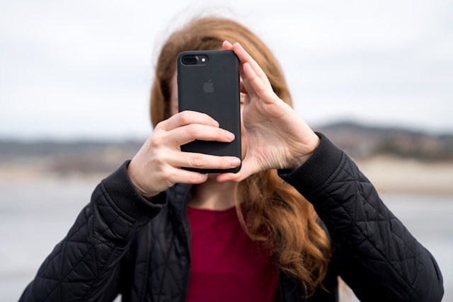 A woman uses her phone camera to record a video for TikTok.
