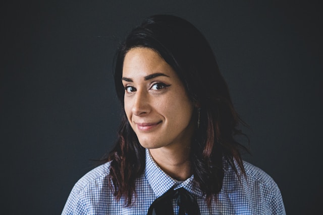 A woman slightly angles her face sideways and wears a small smile for her TikTok profile photo.
