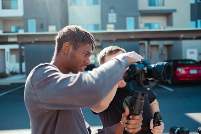 Two creators set up their DSLR camera and look for the right angles for their TikTok video.