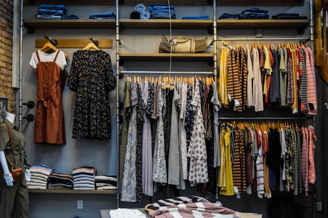 Various vintage outfits are on display in a clothing store.