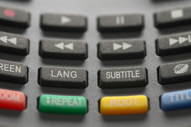 Buttons on a TV remote control show options to turn on subtitles and change the language.