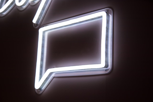 A lighted sign in the shape of a chat bubble.