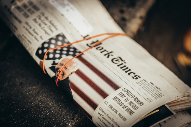 A copy of The New York Times newspaper with a rubber band around it.