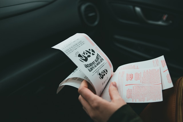 A person holds several lottery tickets.