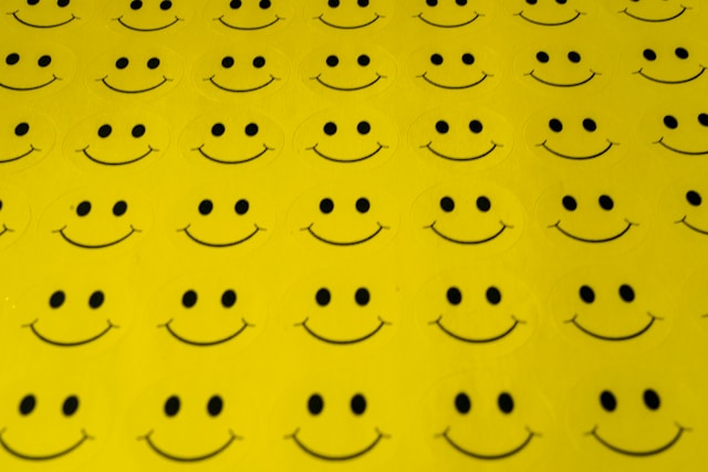A sheet of yellow, smiley face stickers.