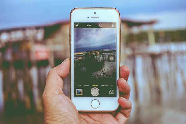 A person takes a photo with an iPhone.
