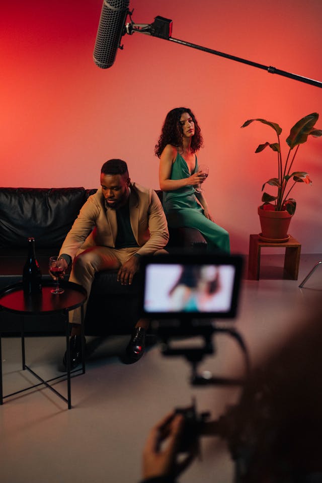 A camera records a man and woman.