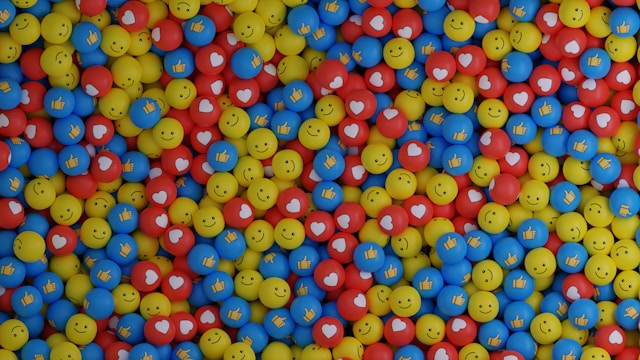 Countless yellow, blue, and red balls with hearts, smiley faces, and thumbs ups.