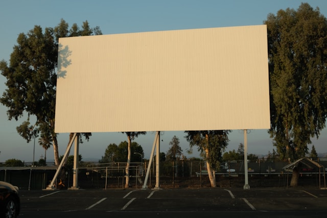 A big, blank billboard in an empty parking lot.