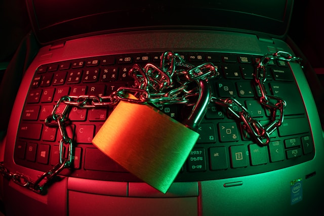 A locked padlock with a chain sits on a laptop keyboard.