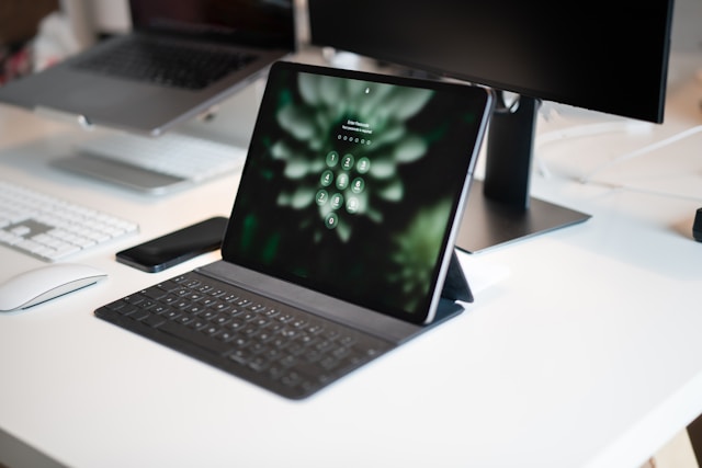 An iPad screen displays a numeric keypad for login access.