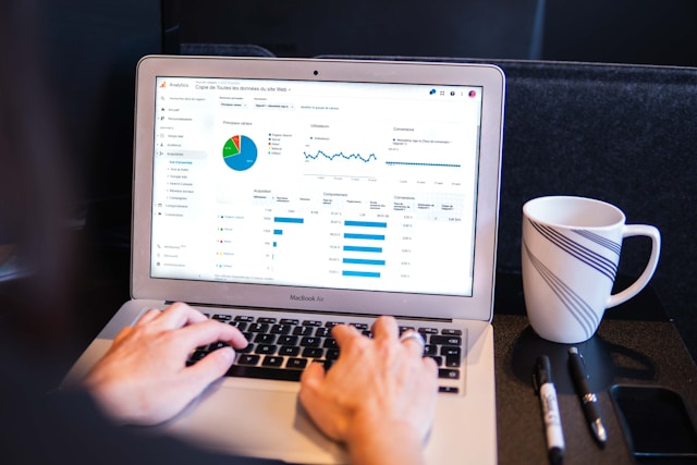 A person analyzes ad analytics on a laptop.