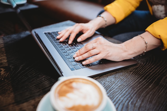 A female professional checks her TikTok analytics on her laptop.