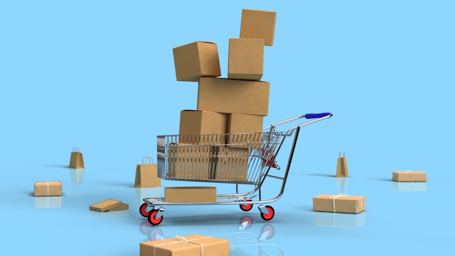 A shopping cart is piled high with brown boxes.