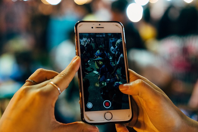 Someone takes a video of others on an iPhone.