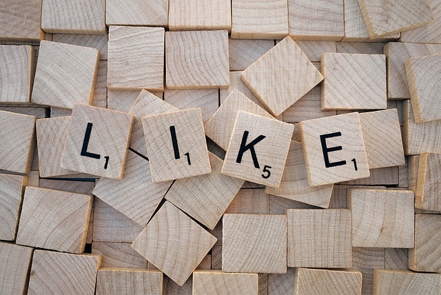 Several Scrabble tiles with alphabets form the word "LIKE."