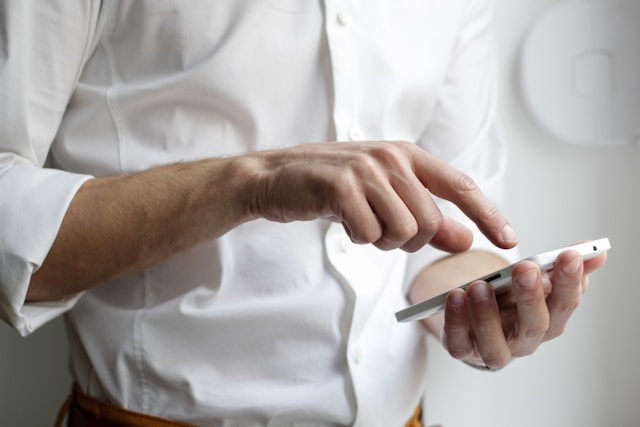 A man browses TikTok videos on his phone.