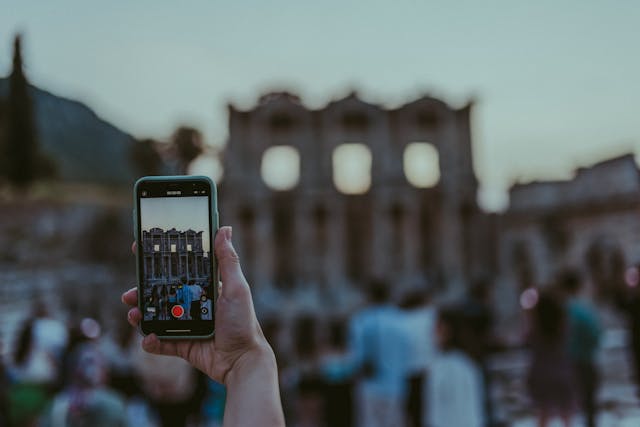 A person records with their cell phone.