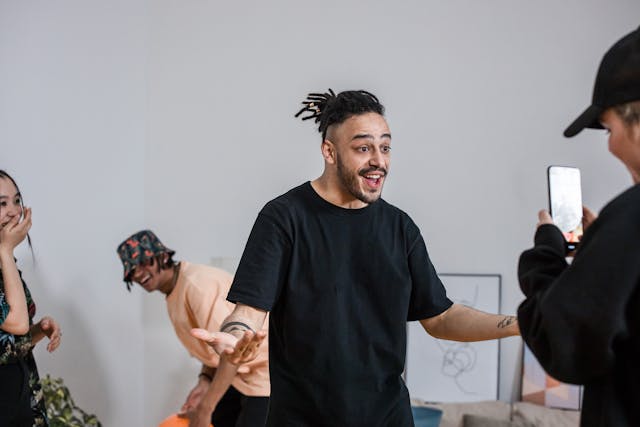 A person records three other people for a video.