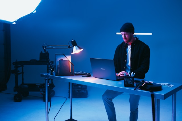 A creator edits his videos on his laptop.