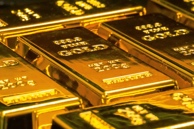 Several rows of gold bars in storage.