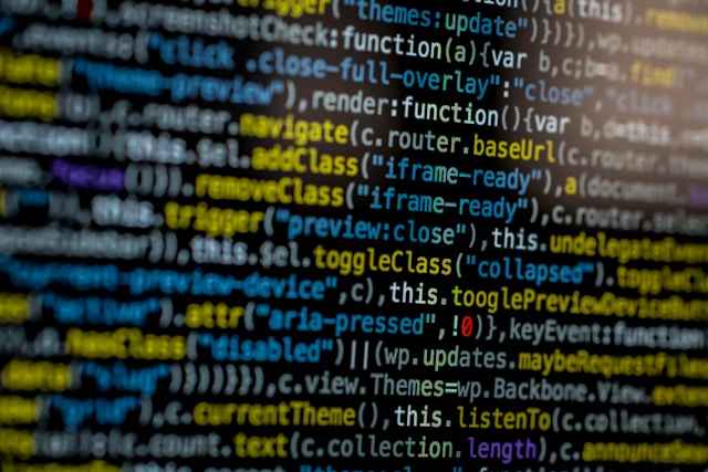 A computer monitor shows lines of programming code.