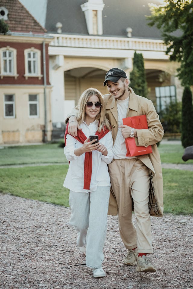 A couple with a woman looking at a phone.