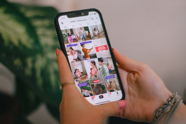 A person browses through TikTok videos on their phone.