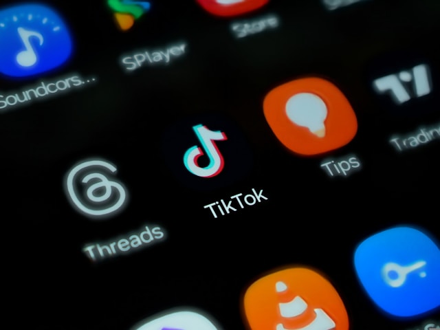 A phone screen displays the TikTok app logo and other app logos.