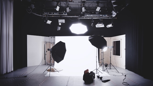 A setup for a TikTok video shows a white background and professional lighting equipment.
