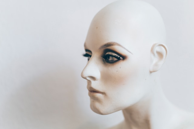 A white mannequin’s head with lifelike facial features.