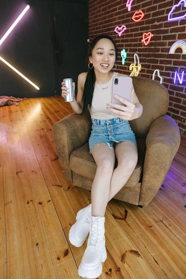A woman records herself talking using her cell phone.