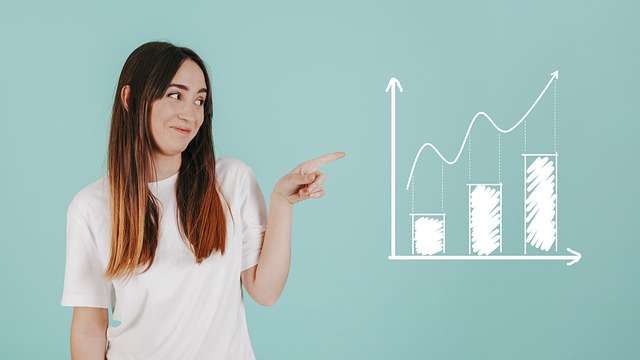 A person points to an upward graph.