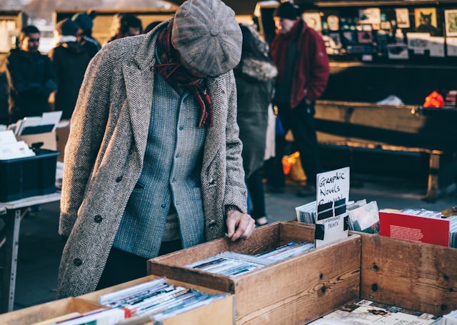 A shopper looks through items in a flea market.