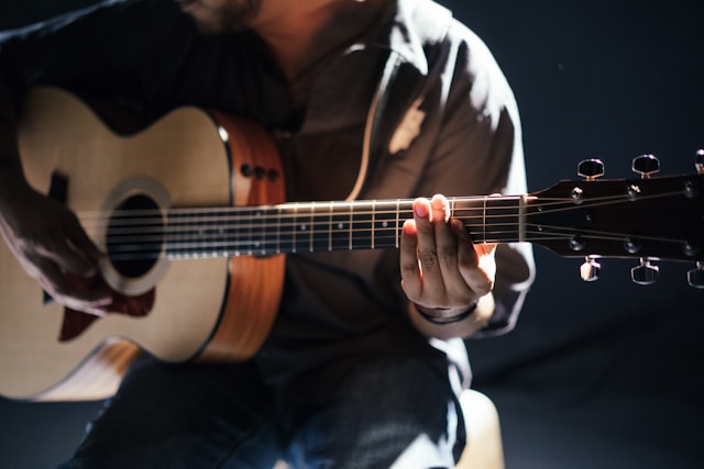 A musician plays the guitar.
