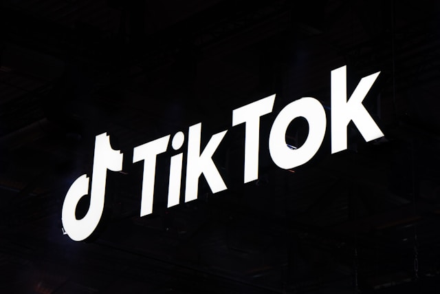 A lighted sign shows the TikTok name and logo.